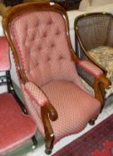 A Victorian mahogany armchair with red and cream ground,