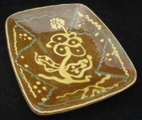 A 19th Century slipware decorated dish on a brown ground,