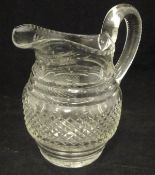 An early 20th Century cut glass jug with starcut base