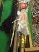 A collection of various walking sticks and parasols including a Victorian bamboo sword stick,