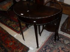 A mahogany demi-line fold-over card table in the George III taste,