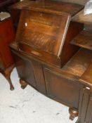 A 20th Century oak dresser with leaded glazed doors flanking the two open tiers upon a base of