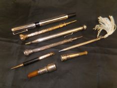 Five various silver/white metal and other propelling pencils and two silver mounted cheroot holders