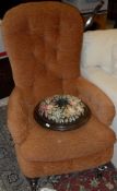 A Victorian button back armchair,