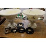 A pair of alabaster dishes on stands,