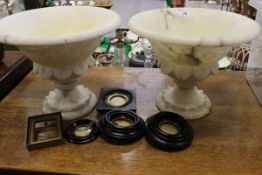 A pair of alabaster dishes on stands,