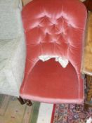 A Victorian pink velvet upholstered button back salon chair on turned front legs to brass caps and