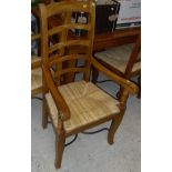 A modern Beech drawer leaf table together with a set of eight ladder back dining chairs with rush