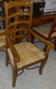 A modern Beech drawer leaf table together with a set of eight ladder back dining chairs with rush