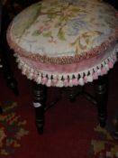 A Victorian tapestry upholstered rectangular dressing stool on baluster turned tapering supports,