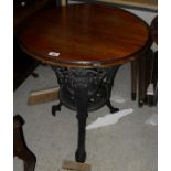 A pair of Victorian cast iron based pub tables with circular mahogany tops