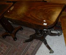 A Victorian mahogany fold-over card table on acanthus carved baluster turned pedestal to splayed