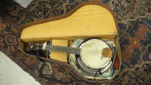 A George Formby branded ukulele banjo with associated case and various music books and three