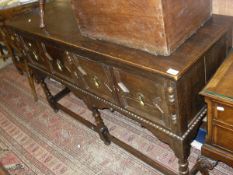 An oak dresser in the 17th Century style with applied moulded decoration,