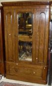 A Victorian mahogany single mirrored door wardrobe above a single drawer