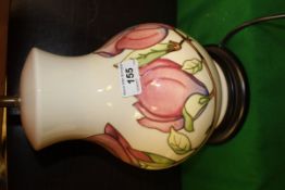 A Moorcroft table lamp base decorated on a cream ground with pink tulips,