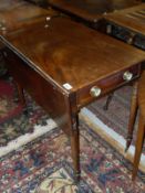 An early 19th Century drop-leaf Pembroke table with single end drawer opposite a dummy drawer on