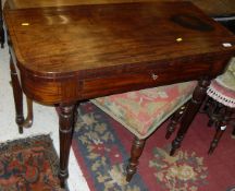 A late Regency mahogany and cross banded fold-over tea table with single frieze drawer on turned