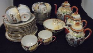 A Japanese eggshell china part tea service decorated with geishas and garden comprising tea cups,