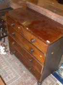 A Victorian mahogany chest of two short over three long graduated drawers with turned knob handles