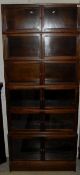 A circa 1900 walnut bookcase of six sections of two glazed doors in the Globe Wernicke style