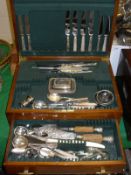 An Art Deco style walnut cutlery canteen containing various cutlery, butter dish, two horn dishes,