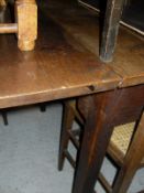 An oak rectangular gate-leg dining table