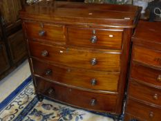 A Victorian mahogany bow fronted chest of two short over three long graduated drawers with turned