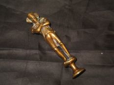 A late Victorian brass pipe tamper decorated with figure of Napoleon standing with arms folded