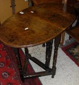 A miniature oak oval single gate-leg drop-leaf occasional table in the 17th Century manner on