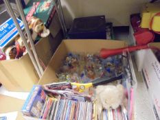 Seven boxes of assorted items to include DVDs, child's games, car battery chargers,