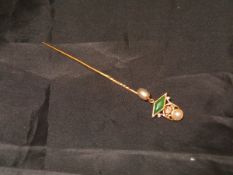 A yellow metal stick pin with diamond emerald and seed pearl decoration