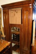 A Victorian mahogany single door wardrobe with moulded pediment above a single drawer
