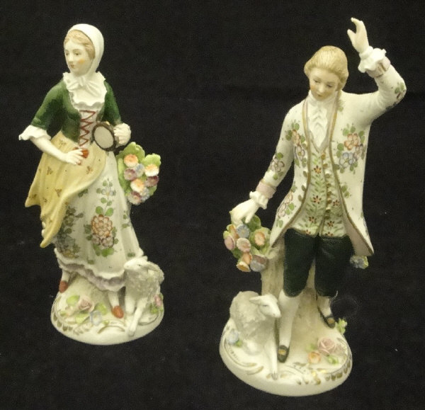 A pair of early 20th Century Sitzendorf figures of a gallant and his lady with tambourine and lamb
