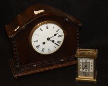 An oak cased mantel clock with Roman numerals to the enamelled dial, the back marked "A1 23507",