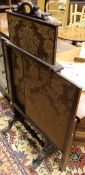 A Victorian mahogany fire screen with rising panel over two sideways sliding panels raised on