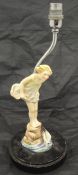 An F G Doughty for Royal Worcester figure of a young girl in yellow dress paddling,