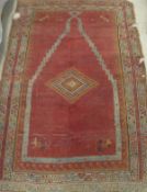 A Turkish style prayer rug, the central penal set with a chequer board effect,