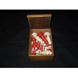 A circa 1900 turned bone and red stained bone chess set