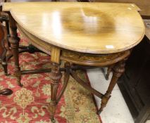 A circa 1900 rosewood folover card table of demi lune form,