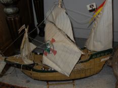 A solid yew burr, a wooden model of the ship "Santa Maria", a cased wooden model galleon,