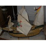 A solid yew burr, a wooden model of the ship "Santa Maria", a cased wooden model galleon,