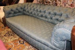 A Victorian Chesterfield button back sofa in a green self patterned upholstery on mahogany square
