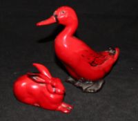 A Royal Doulton flambé figure of a duck and another of a seated hare,
