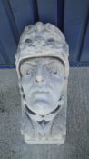 A pair of 19th Century large carved Portland stone corbels each depicting a head with helmet