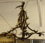 A four branch electrolier with resin body in the form of various interlocking antlers