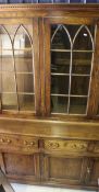 A modern oak dresser with glazed top together with a similar bedside cupboard,