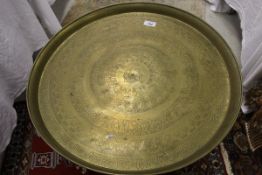 An Egyptian brass tray decorated with concentric rings featuring hieroglyphics,