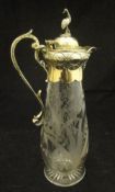 A cut glass and gilt metal mounted claret jug with floral spray decoration,