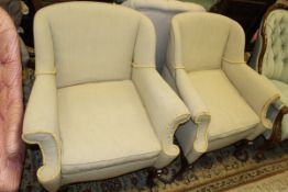 Two Victorian armchairs in a cream and green striped upholstery to cabriole front legs